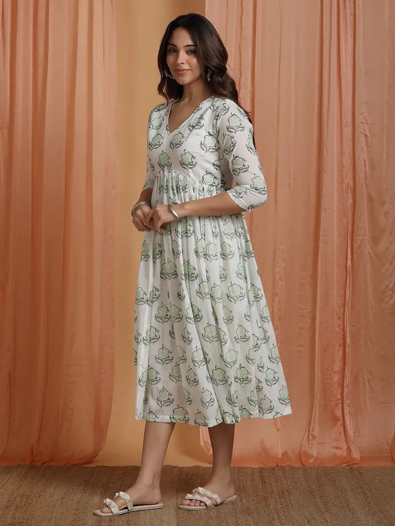model wearing green block printed cotton dress — V‑neck, ¾ sleeves