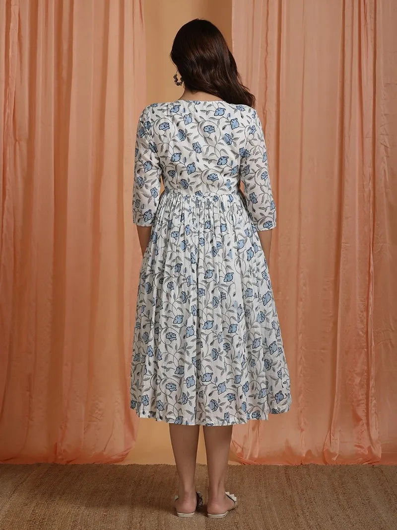 model in blue off‑white block print dress – side view