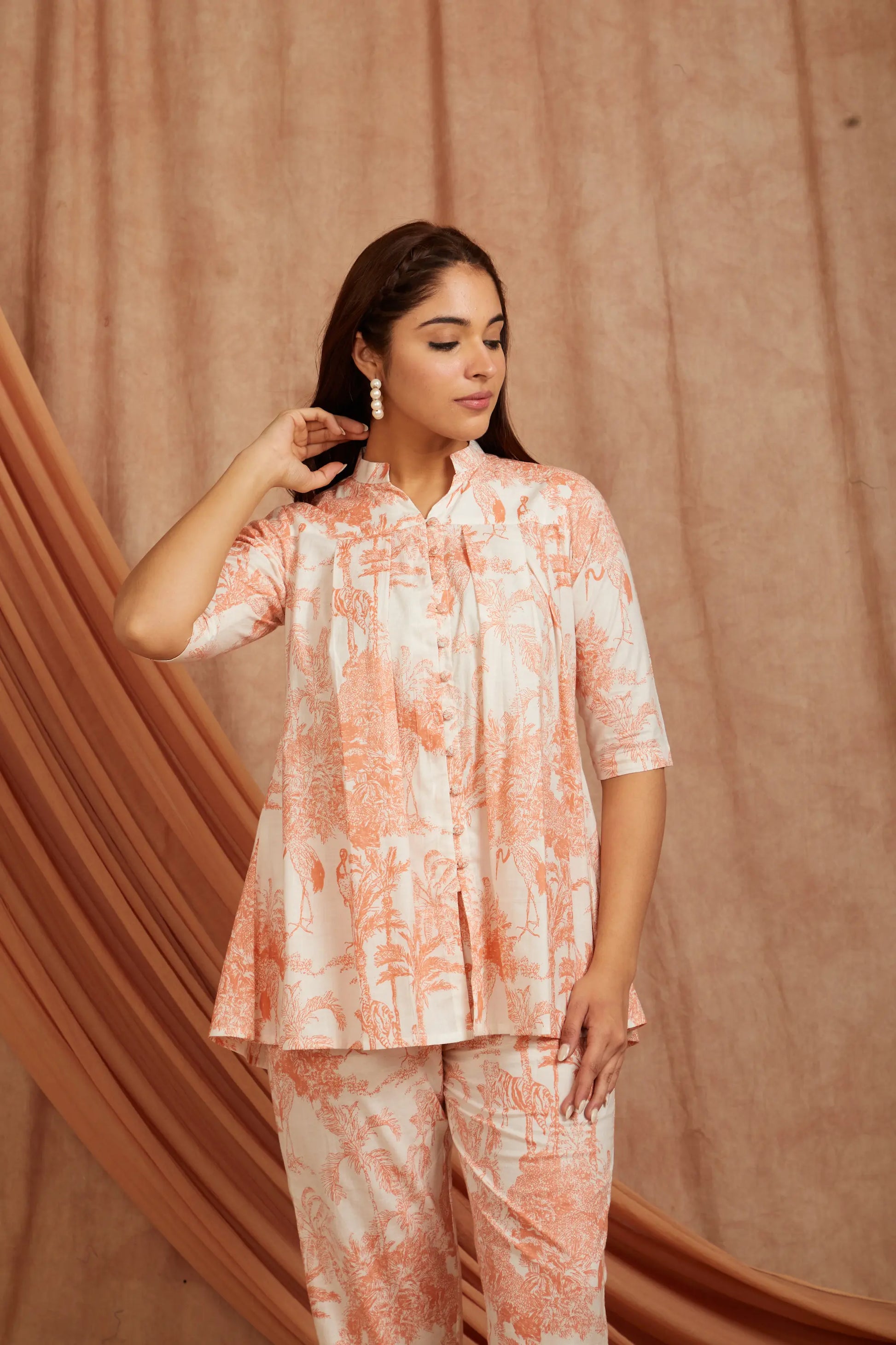 close‑up of white fabric with peach block print details