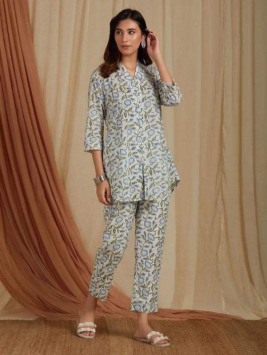 front view of off-white top with blue floral print and pants